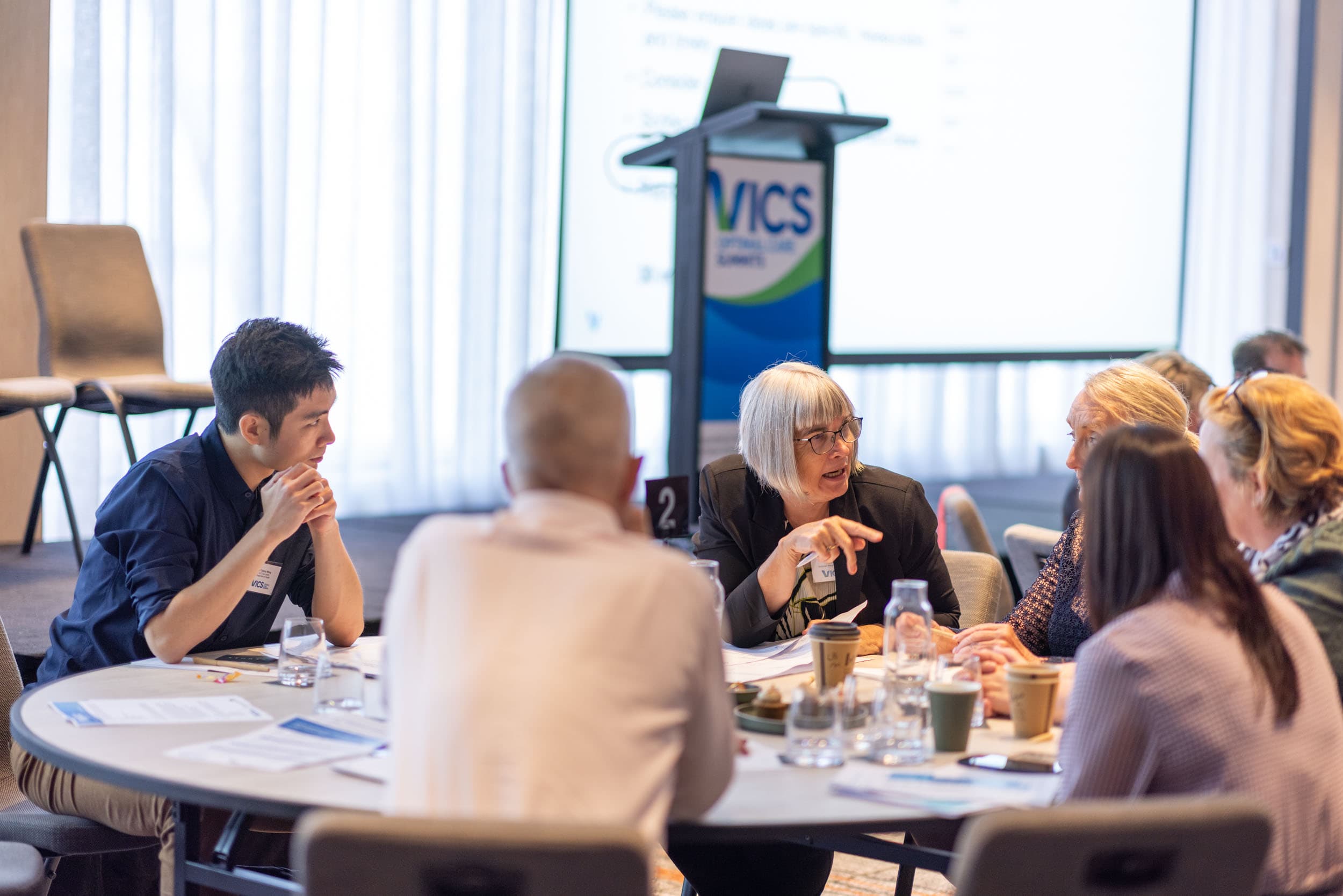 5 people around a table at a VICS Optimal Care Summit