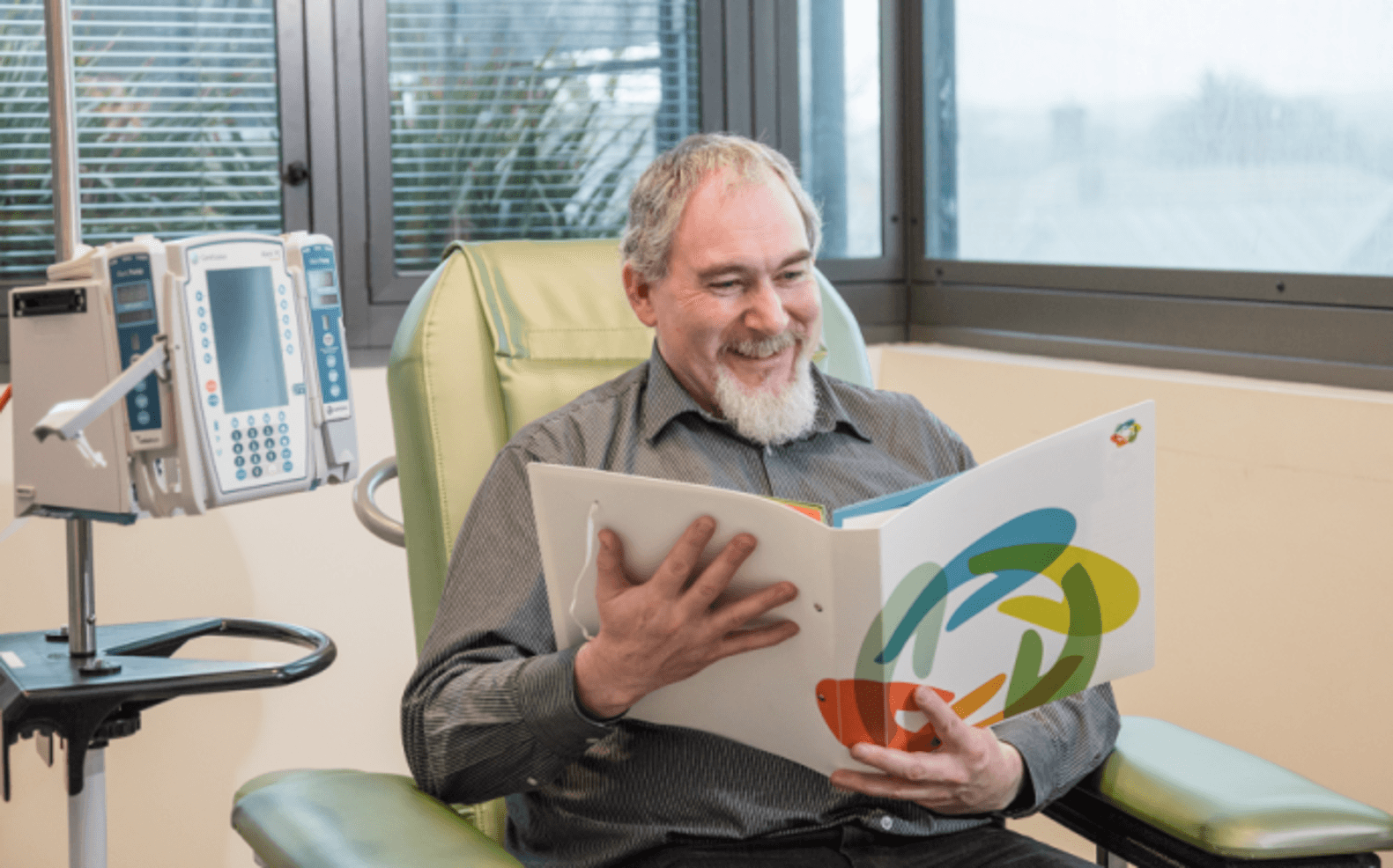 Image of a man looking at a My Cancer Care Record folder
